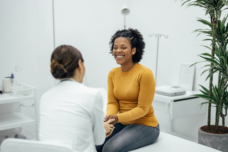 Excited woman happy to hear good news from a doctor at private practice