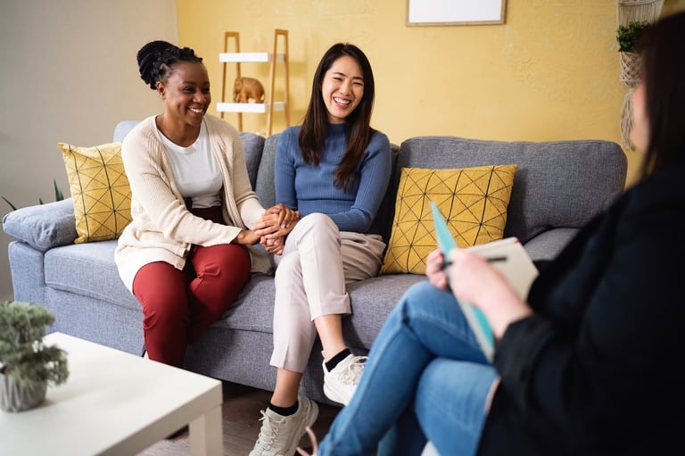 Multiracial lesbian couple having couple therapy with female Caucasian psychotherapist