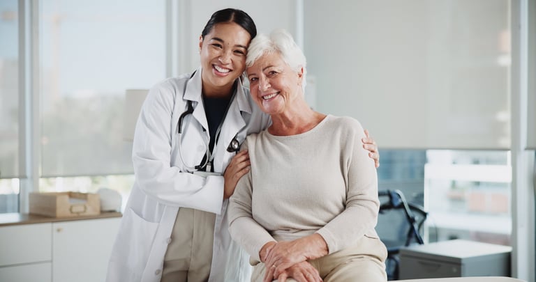 Senior woman hugging doctor at clinic with support and kindness