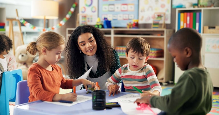 Teacher with diverse children in classroom for creative learning and child development